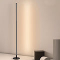 Slim cylindrical floor lamp in matte black and white with soft diffused glow — Minimalist Floor Lamp — Touched Home
