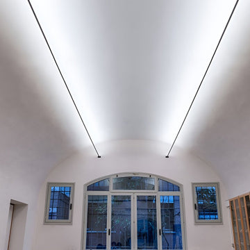 Ultra-thin linear LED light stretching across a minimalist ceiling — Skyline Line Light — Touched Home